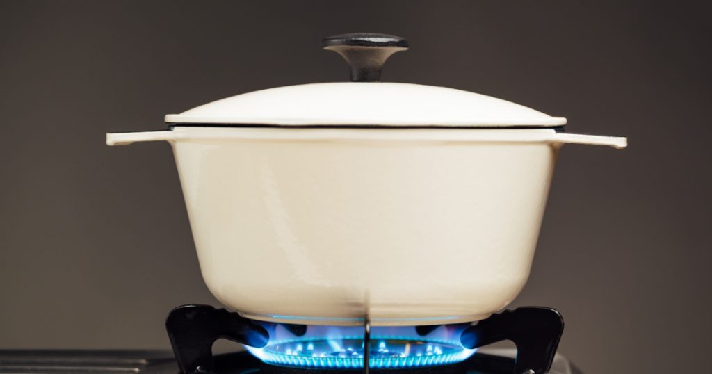 white cast iron saucepan on the gas stove
