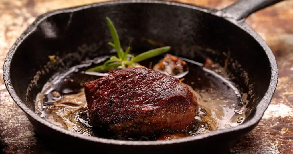 Beef steak on cast iron skillet with empty space for text
