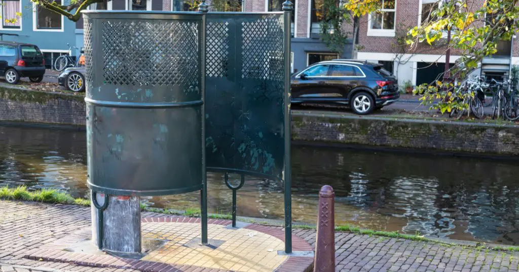 Outdoor urinals, a public toilet - Plaskrul, for men along the canal in the center of Amsterdam.
