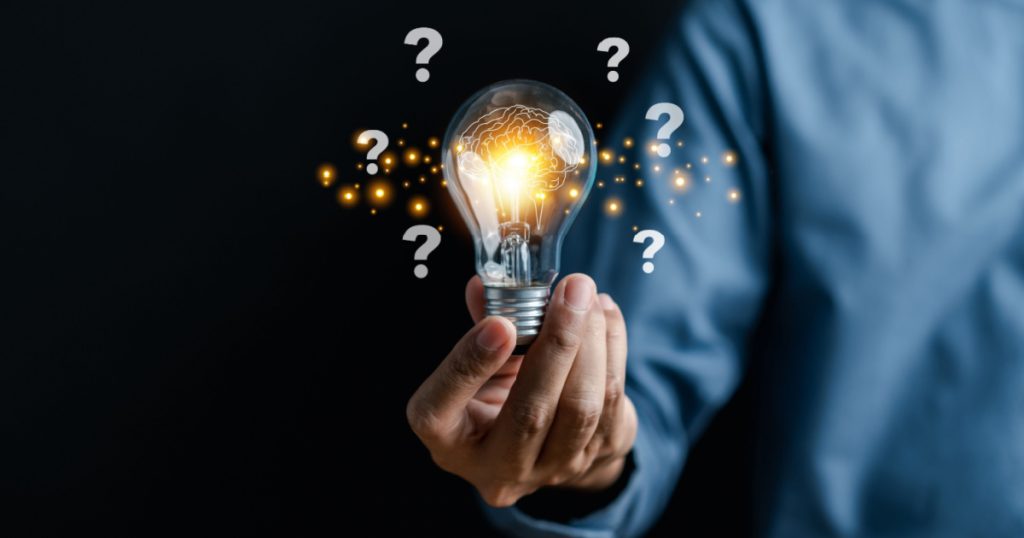 Businessman hand holding light bulb with brain into smart, creative, idea thinking to innovation brainstorm and imagination learning educate concept.
