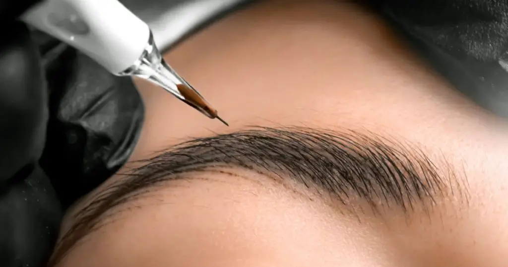 Eyebrows tattoo or Permanent Makeup. Detail of beautiful woman, eyebrow with nice black Brows In Beauty Salon. Beauty eyebrow upgrade procedure.