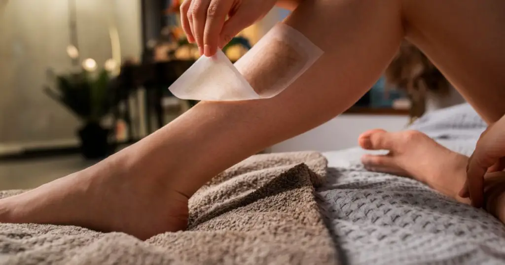 woman waxing leg. waxing female legs at home. young woman's leg for hair removal. Woman body care. waxing for legs with perfect smooth soft skin. beauty and health concept.
