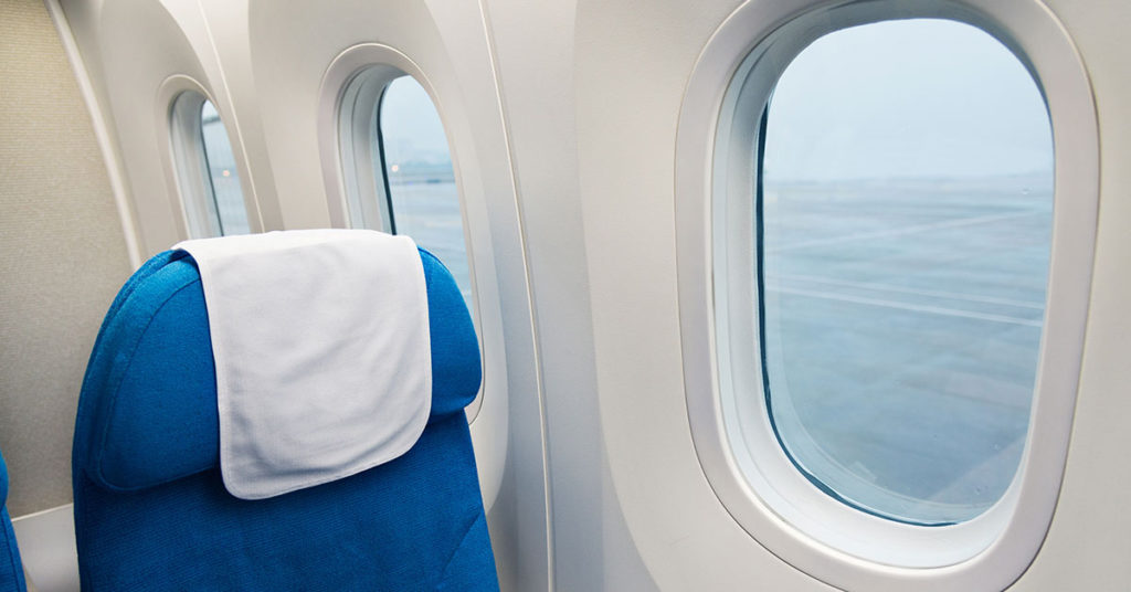 What Do Those Triangle Stickers Above Your Airplane Seat Mean? - Featured image