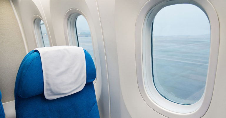 What Do Those Triangle Stickers Above Your Airplane Seat Mean? - Featured image