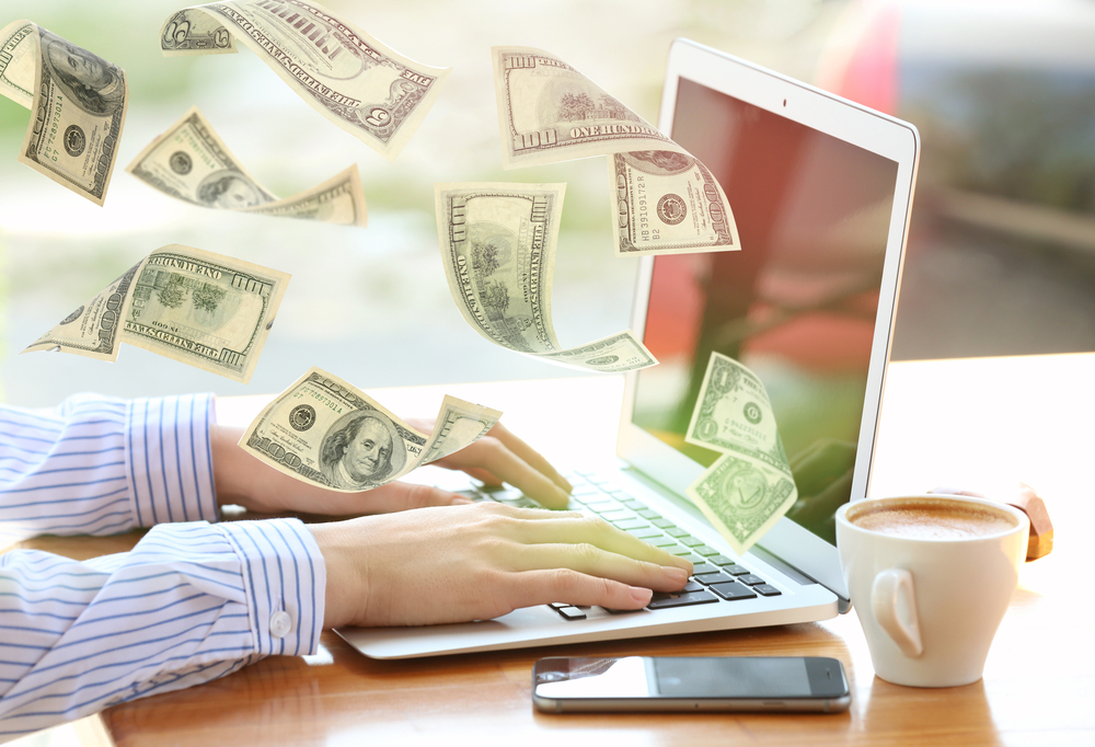 money flying from laptop