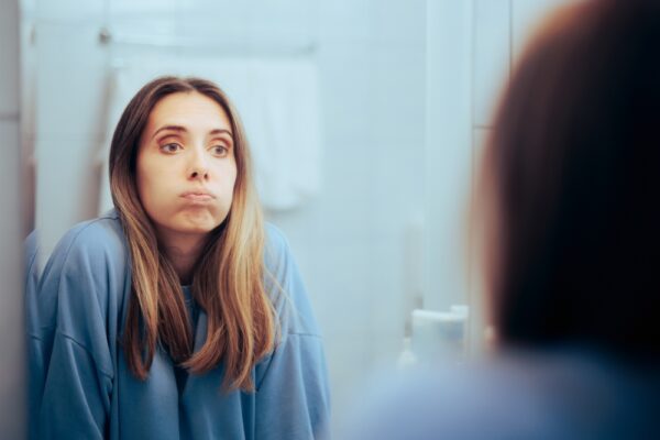 woman looking in the mirror