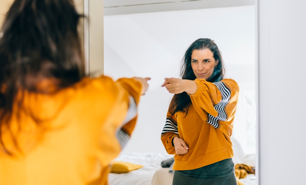 woman looking in mirror