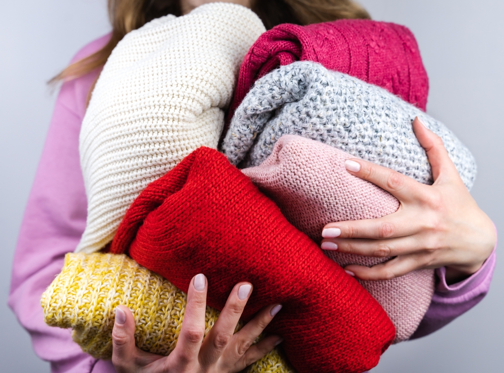 woman holding colour clothes