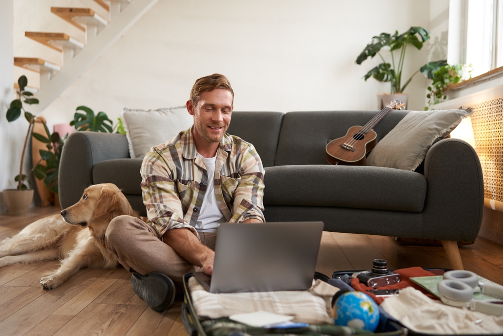 man sitting on floor with dog