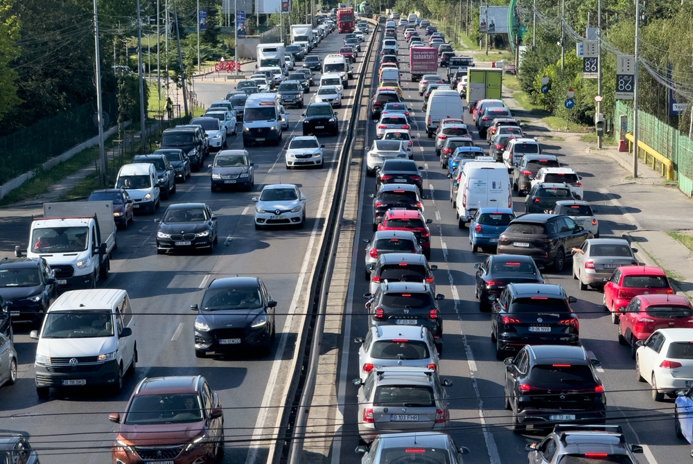Bucharest, Romania - 8 June 2024: Standstill traffic in Bucharest. View from above to rush hour traffic at the entrance in Bucharest during a summer morning. Transportation industry in Romania.
