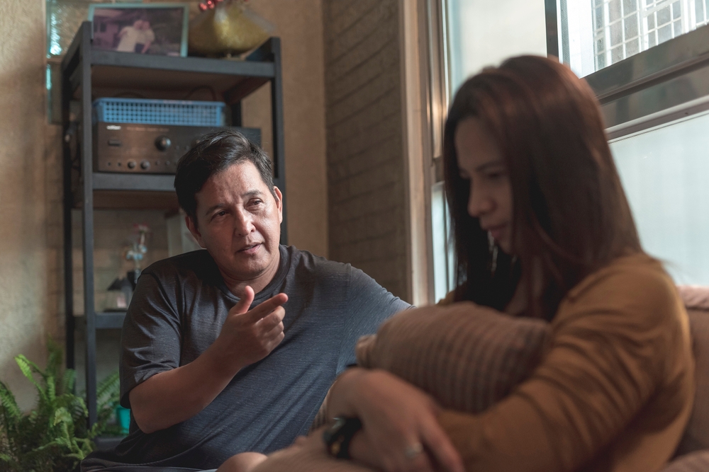 A man tries to justify his actions to his upset wife. Marital problems and disagreements in a couple.